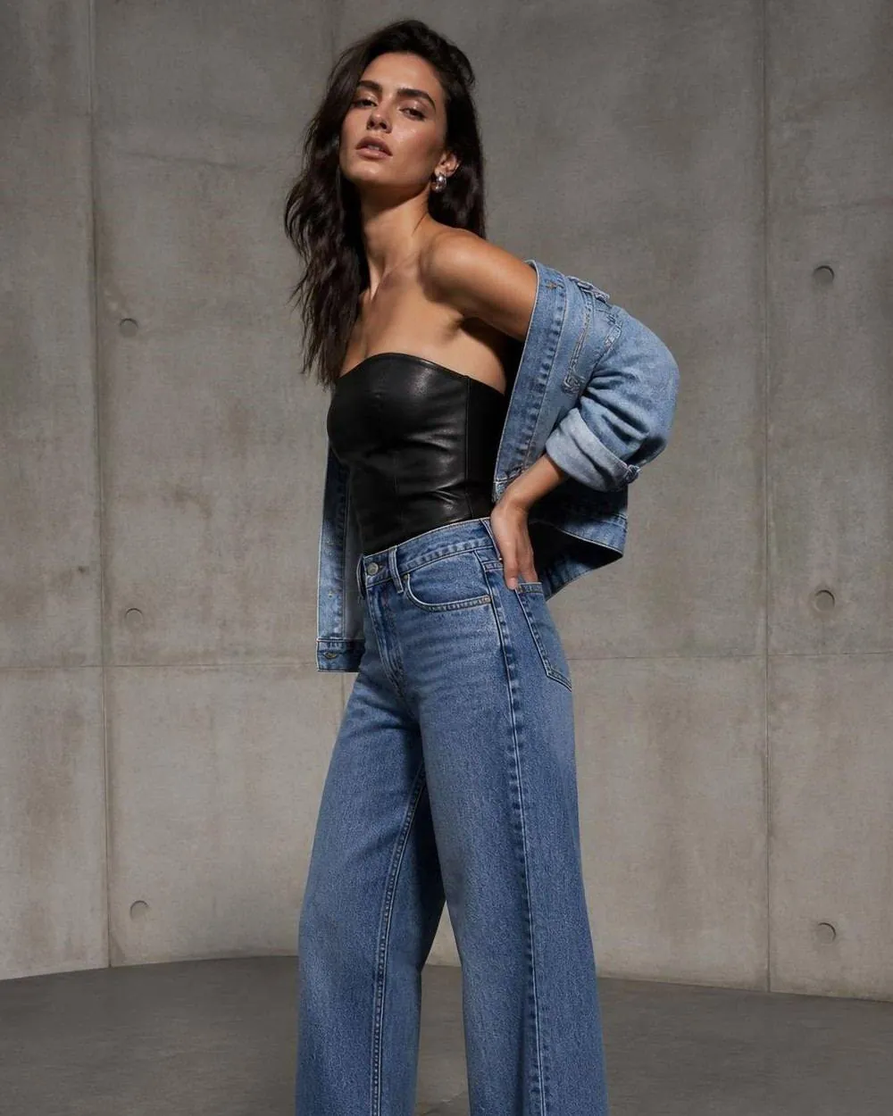 Model in a mid-wash wide-leg denim look